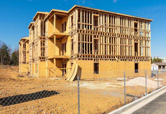 workers protected by temporary barrier fence during building maintenance in Lindsay CA